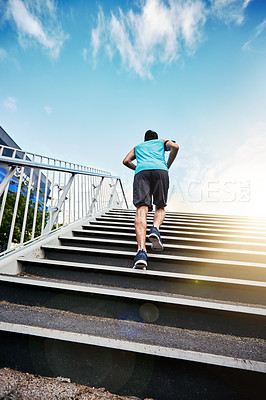 Buy stock photo Rearview shot of a handsome young man working out in the city