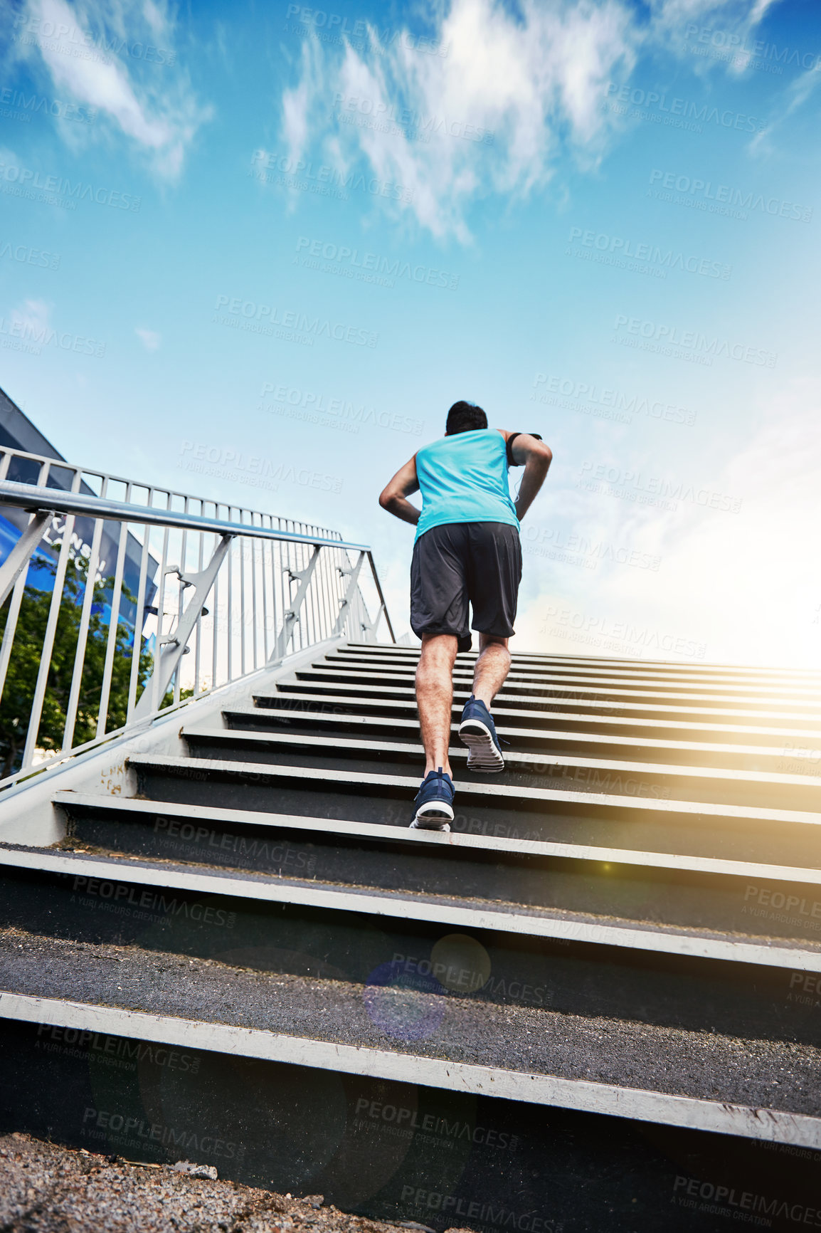 Buy stock photo Back, exercise and running with man, stairs and energy with progress, sunshine and challenge. Outdoor, steps and runner in city, low angle and training for wellness, healthy and fitness with workout