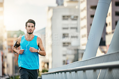 Buy stock photo Cropped shot of a handsome young man working out in the city
