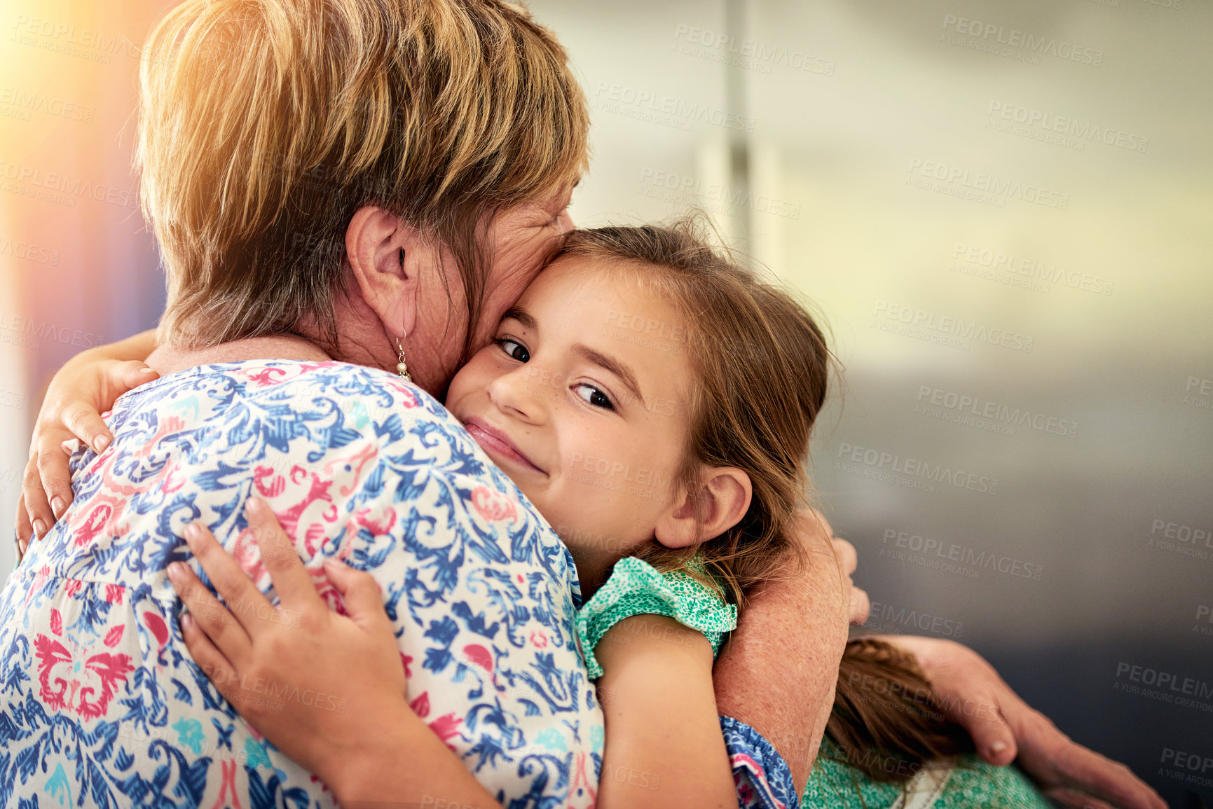 Buy stock photo Family, hug and grandmother with girl, love and happiness for care, bonding together and apartment. Face, mature person for grandchild or senior woman, cheerful kid or embrace for grandma support