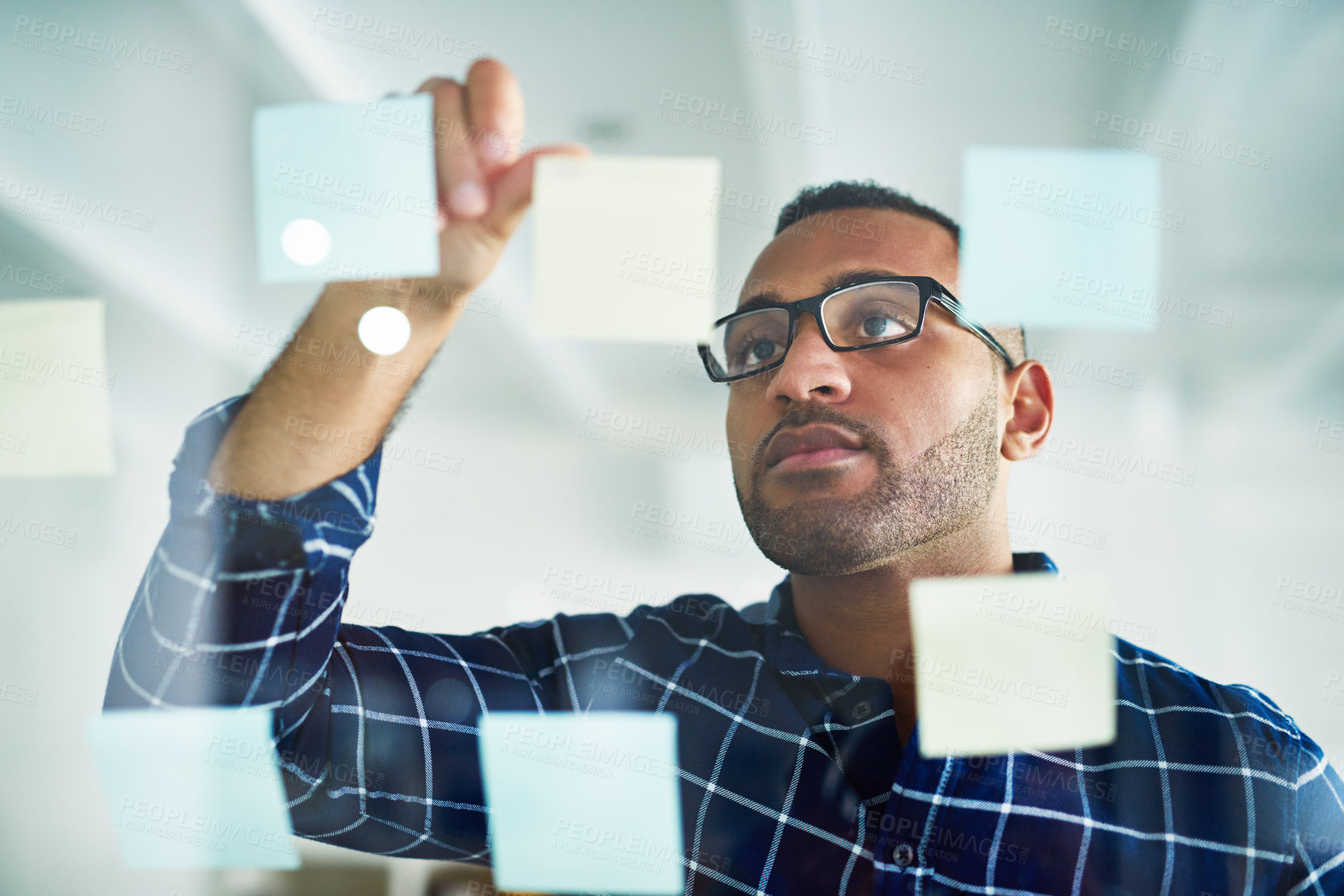 Buy stock photo Brainstorming, sticky note and black man on glass wall for business, schedule or planning startup idea. Paper, creative or problem solving for solution, mind map or web designer on software project