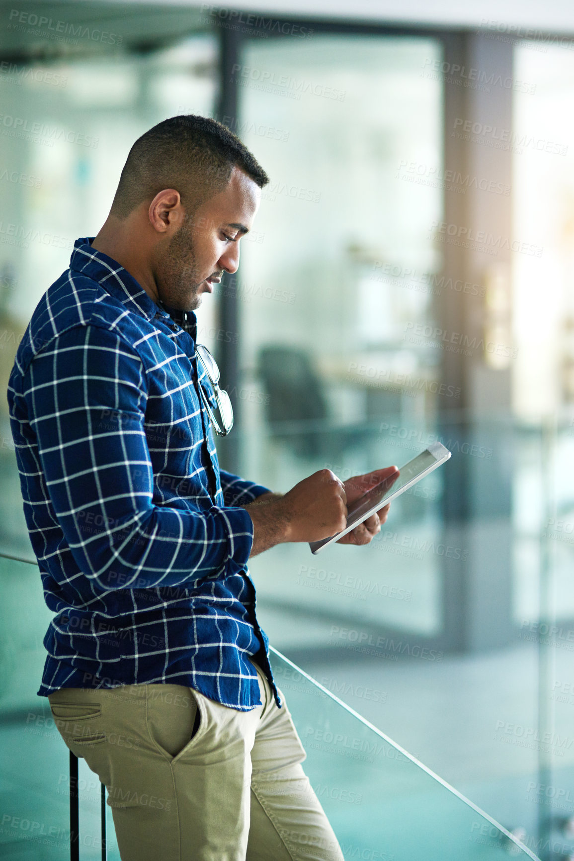 Buy stock photo Black man, reading and tablet in office with scroll for career, social media management for company. Professional, creative or male person with ebook for research with email marketing, search or post