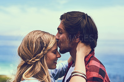 Buy stock photo Shot of an affectionate young couple enjoying a hike in the mountains