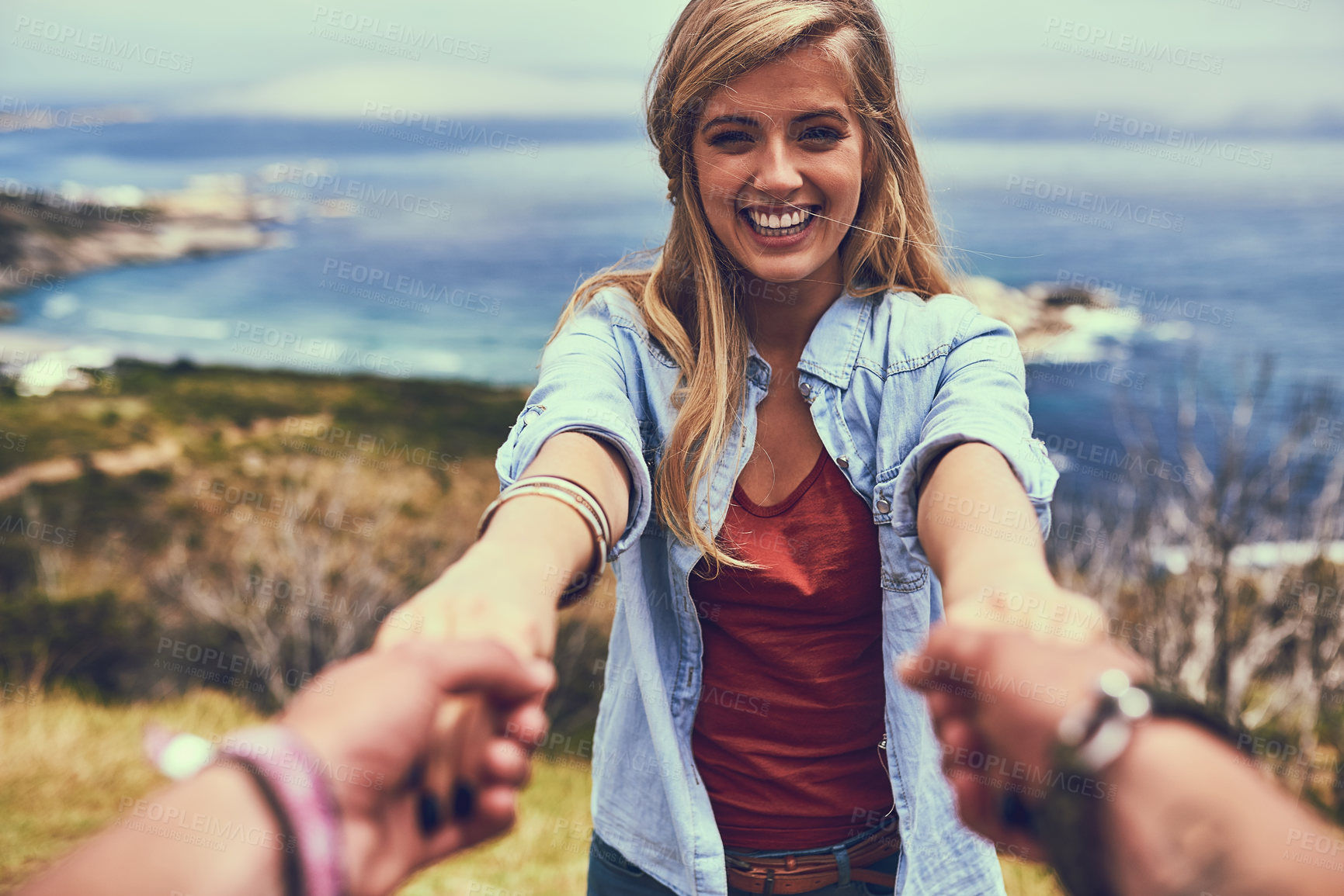 Buy stock photo Shot of an affectionate young couple enjoying a hike in the mountains