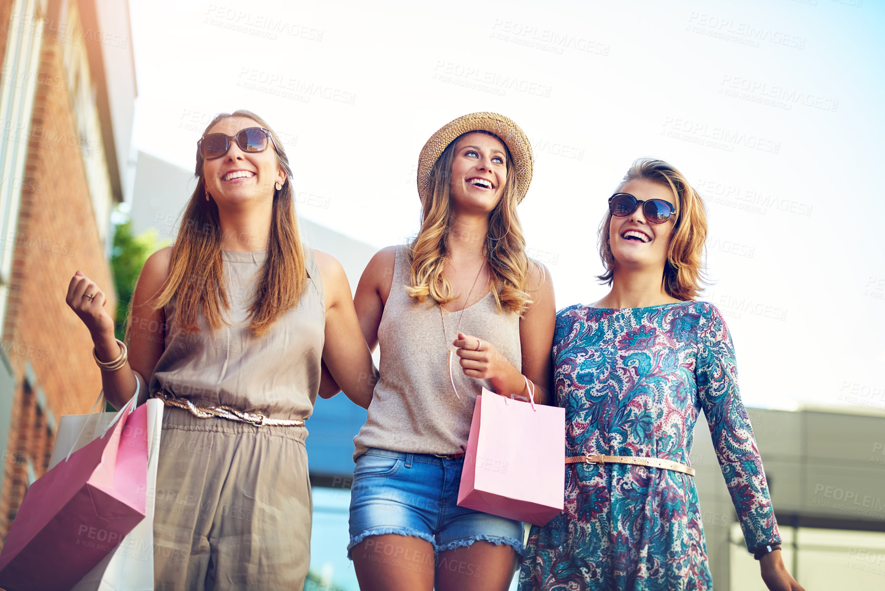 Buy stock photo Women, group and shopping in city for discount, boutique sale and happiness in summer. Girl friends, laughing and walking with paper bags for luxury, reunion and commerce together for bonding