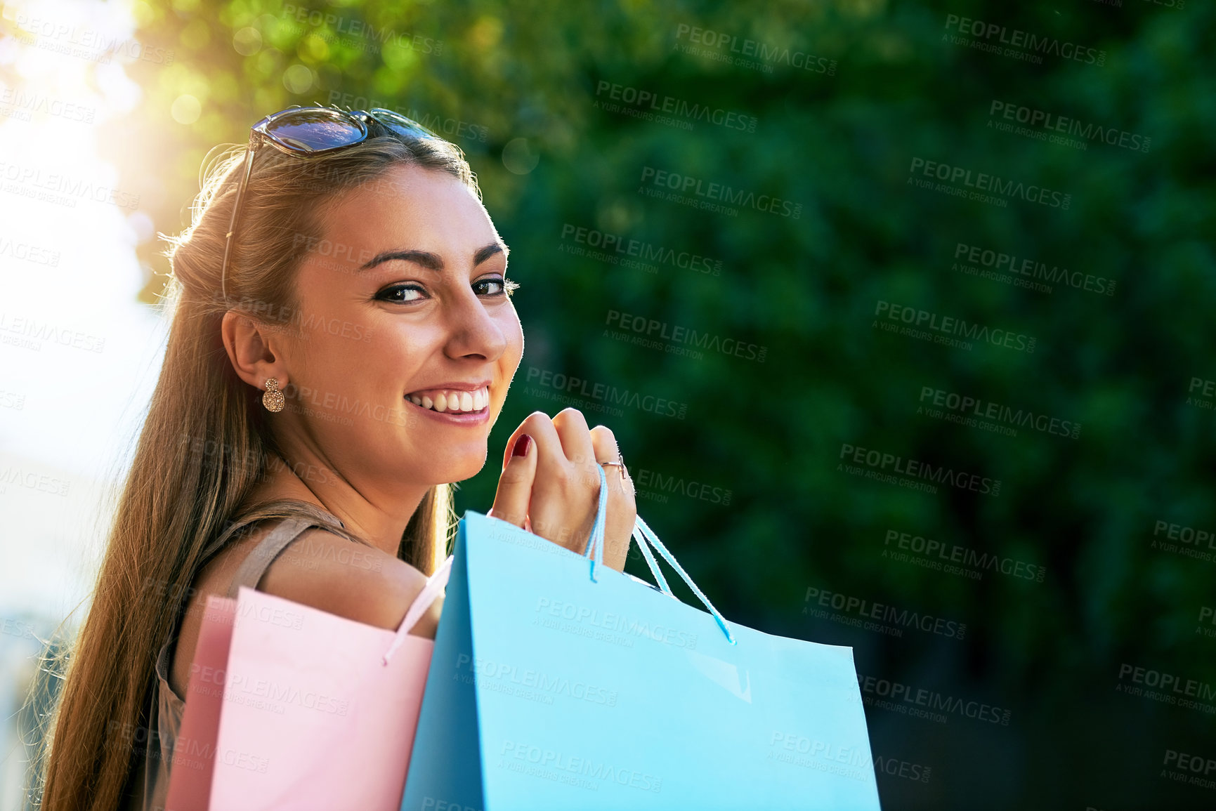 Buy stock photo Shopping, woman and portrait in city for retail, fashion and happiness for sale in street. Customer, bags and female person on sidewalk and trees or smile for sunshine, deal or discount on weekend