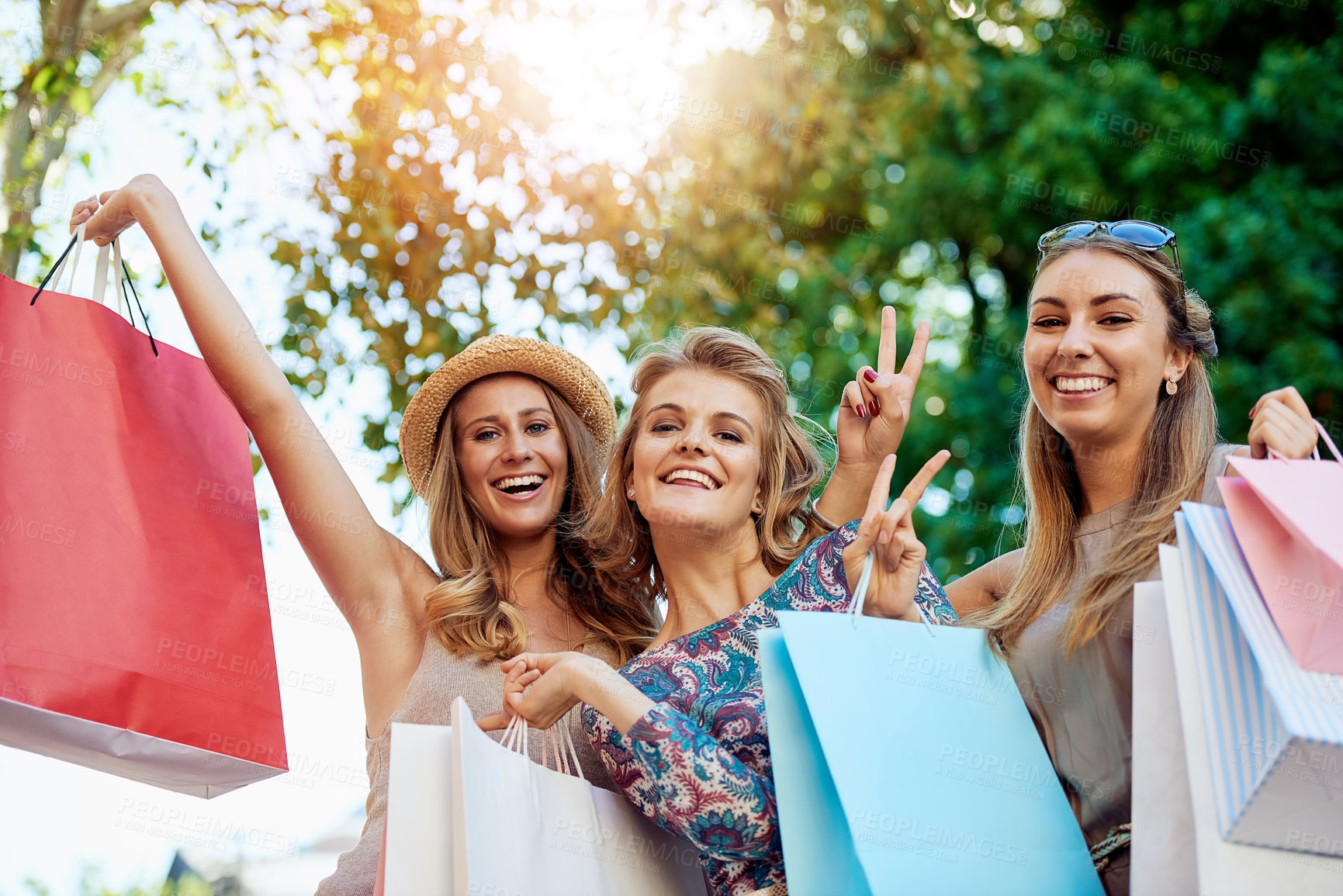 Buy stock photo Cropped portrait of three young girlfriends shopping in the city center