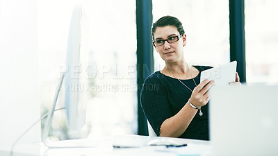 Buy stock photo Shot of a young businesswoman working at her desk in an office