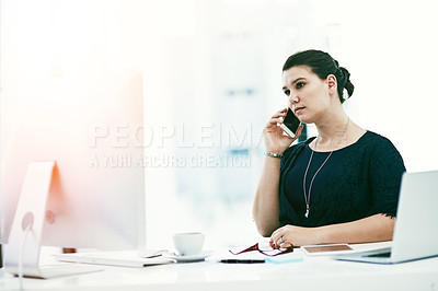 Buy stock photo Shot of a young businesswoman working at her desk in an office