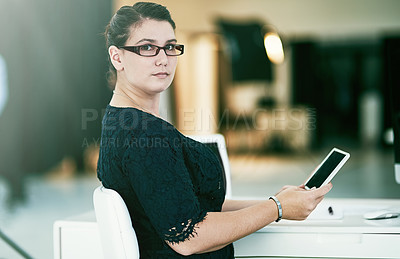Buy stock photo Portrait of a young businesswoman working at her desk in an office
