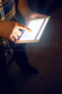 Buy stock photo Cropped shot of a male designer working on a digital tablet late in the office