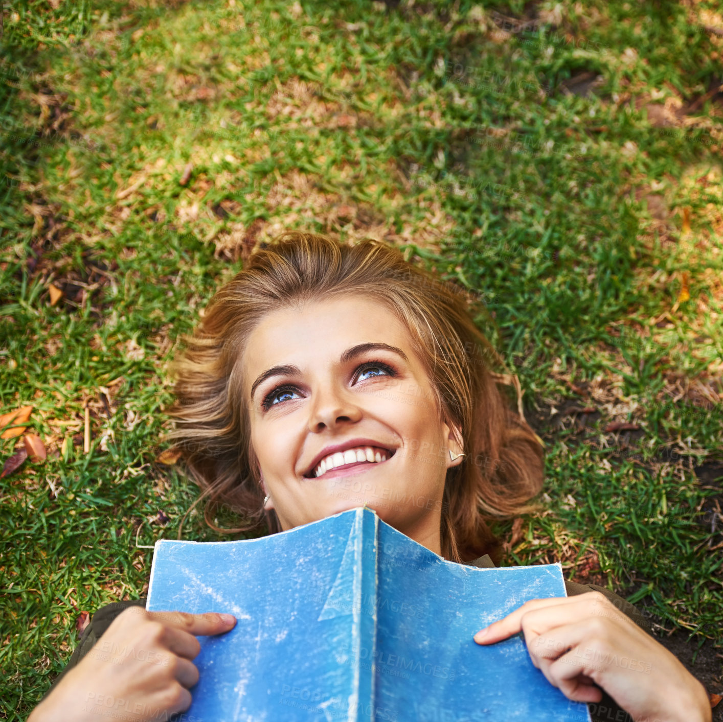 Buy stock photo Girl, thinking and relax in garden with book for reading, fantasy and romance novel or love poetry with smile. Woman, outdoor and thoughts of emotion for romantic literature, hobby and calm on grass.