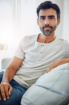 Buy stock photo Indian man, portrait and serious or relax on sofa with confidence, comfortable and weekend break in home. Person, calm and pride on couch of house for me time, rest and peaceful leisure in apartment