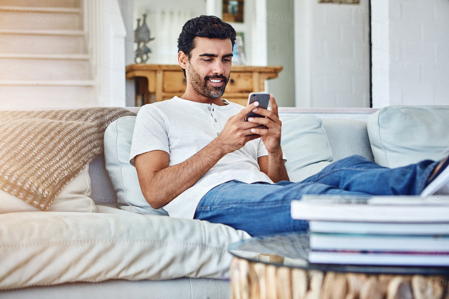 Buy stock photo Online, mobile and man texting on sofa for social media, communication or notification in living room. Contact, connection and person with smartphone for typing, networking or internet app in home