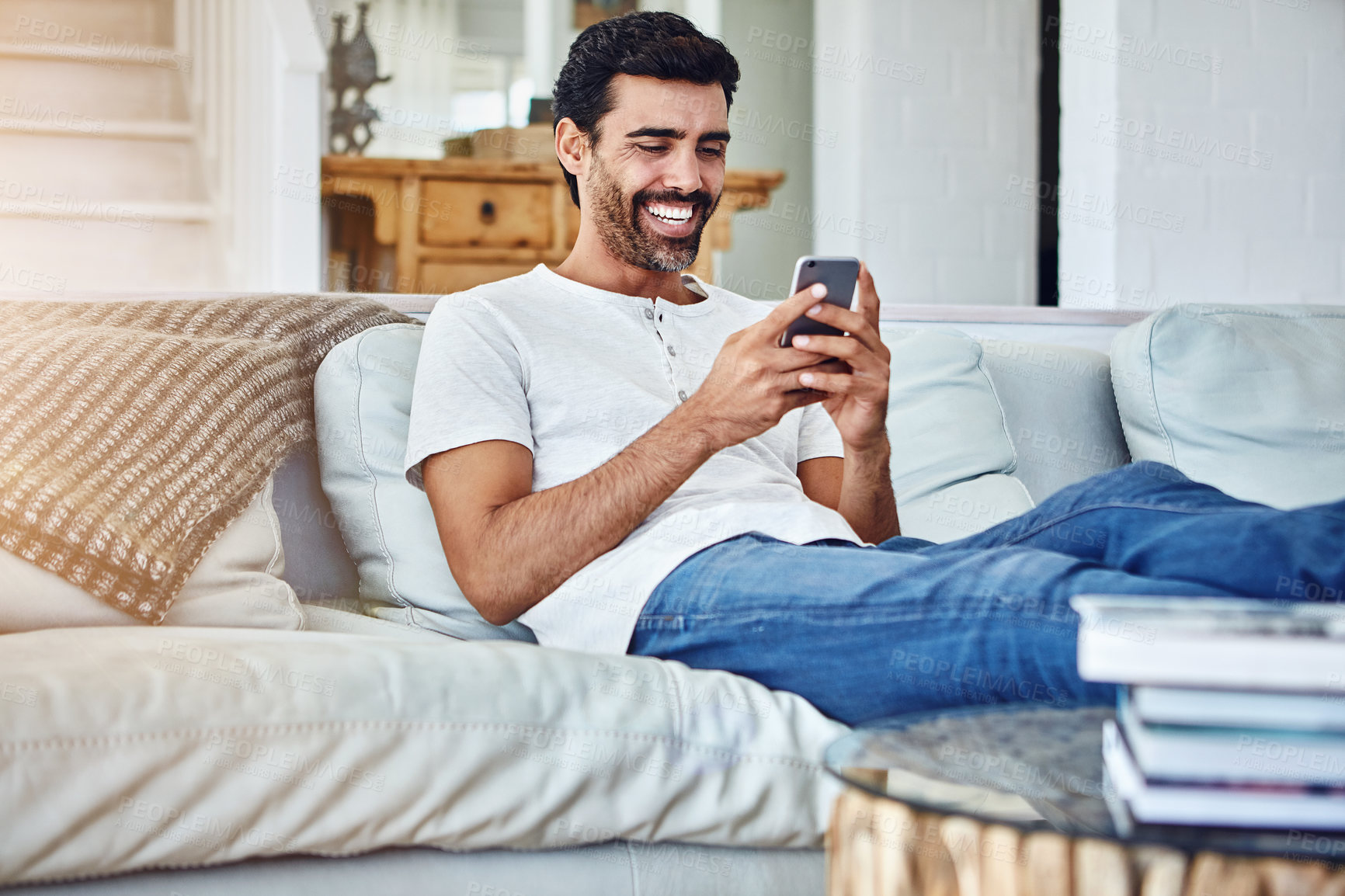 Buy stock photo Happiness, man and smartphone on sofa for texting, communication or notification in living room. Online, connection and male person with mobile phone for social media, networking or internet in home