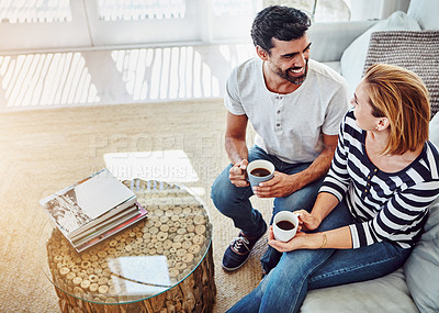 Buy stock photo High angle shot of an affectionate young couple having coffee together at home