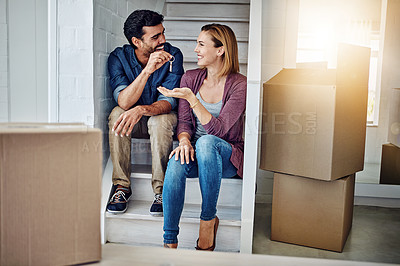 Buy stock photo Shot of a man handing his wife the keys to their new home