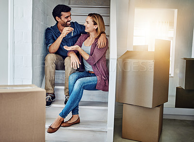 Buy stock photo Shot of a man handing his wife the keys of their new home
