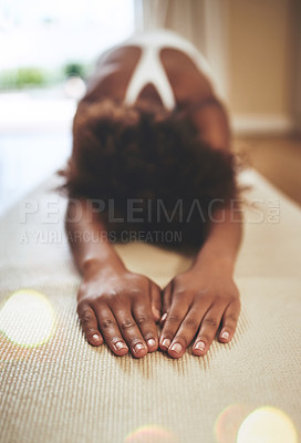 Buy stock photo Full length shot of an unrecognizable young woman practicing yoga indoors