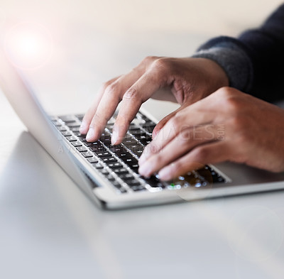 Buy stock photo Cropped closeup shot of an unrecognizable man sitting at a table using a laptop