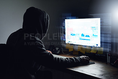 Buy stock photo Rearview shot of a young programmer working on his computer late at night