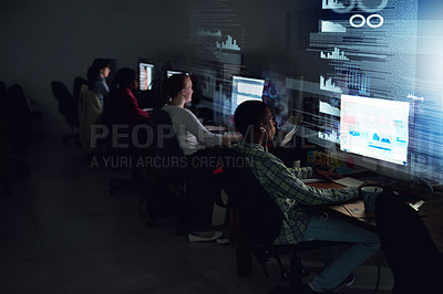 Buy stock photo Rear view shot of a team of programmers coding through the night