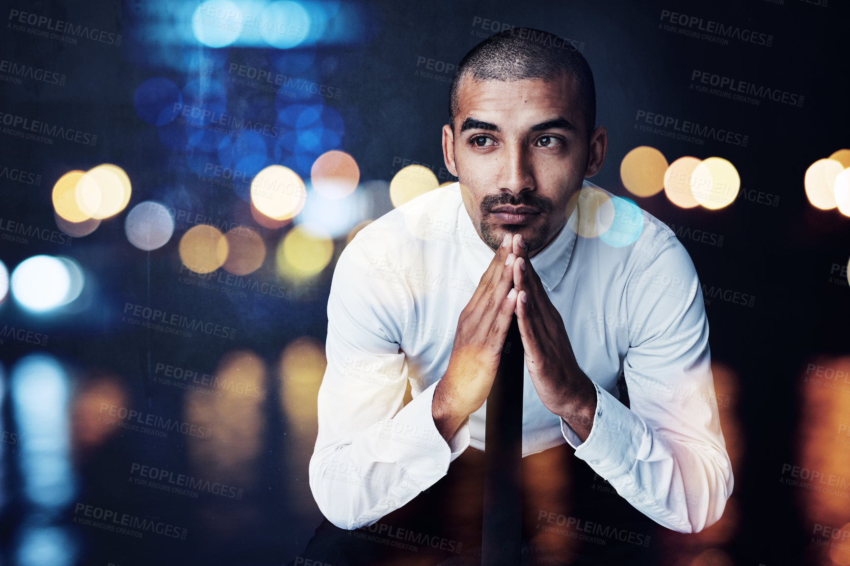 Buy stock photo Shot of a young businessman lost in thought against a defocussed background