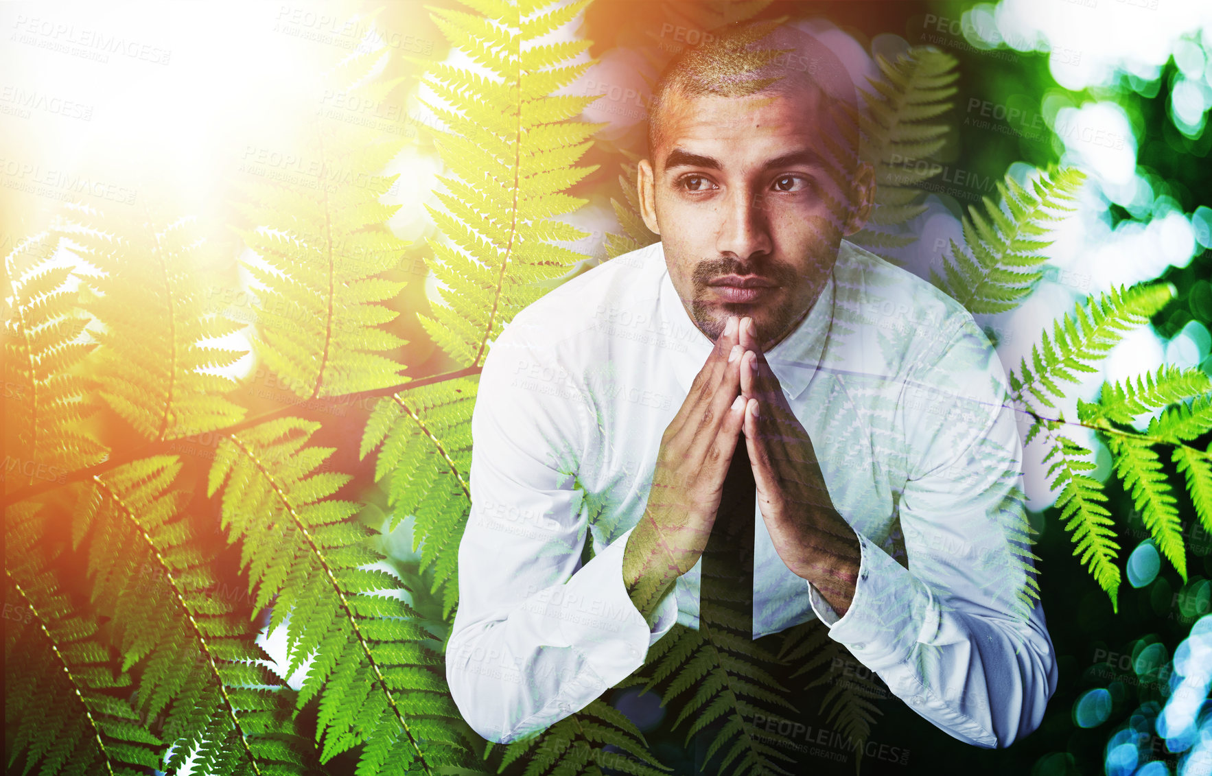 Buy stock photo Shot of a young businessman lost in though superimposed over a nature background