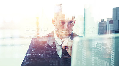 Buy stock photo Shot of a focussed businessman using his computer superimposed over a cityscape