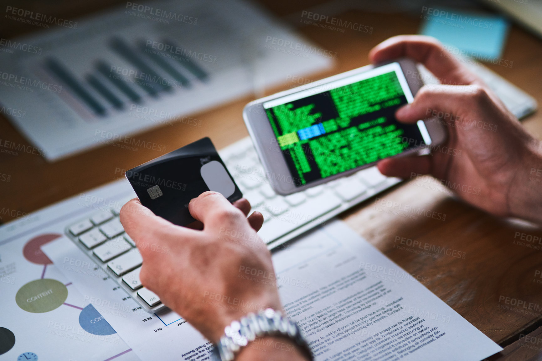 Buy stock photo Cybersecurity issues or credit card theft by a hacker using his phone screen to write code. Closeup of the hands of man working on an interface programming for internet theft or unauthorized payment