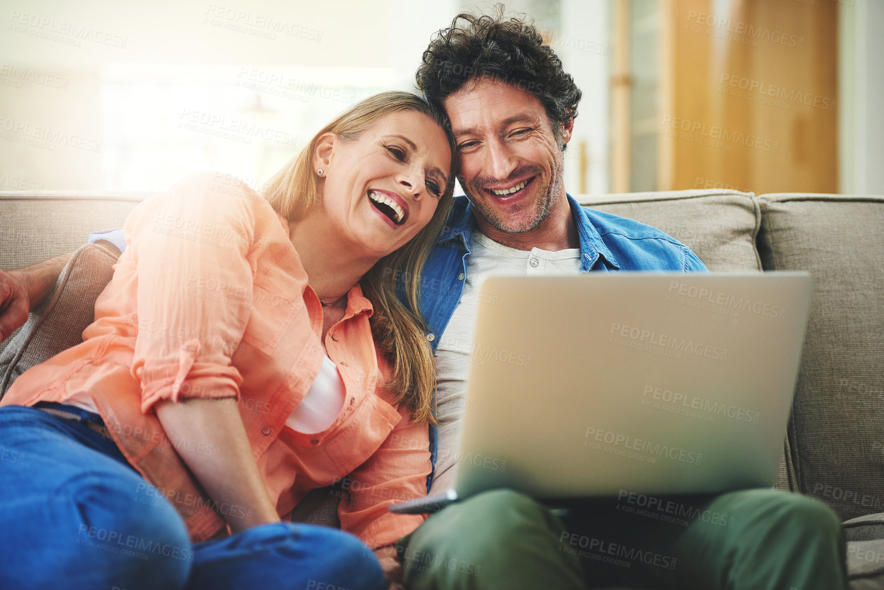 Buy stock photo Couple, laptop and couch in home, relax and point for choice with movie, show or streaming subscription. Mature people, man and woman with computer on sofa in living room with talking, film and smile