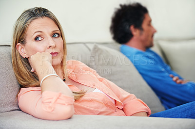 Buy stock photo Shot of a mature couple not speaking to each other after a disagreement at home