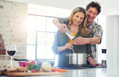 Buy stock photo Love, recipe and salt with a couple cooking in the kitchen of their home together for health, diet or nutrition. Smile, food or seasoning with a happy mature man and woman in their house for flavor