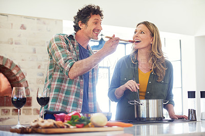 Buy stock photo Shot of a happy mature couple preparing a meal together at home