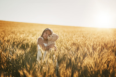 Buy stock photo Outdoor portrait, girl and teddy bear hug for development, security and mockup space in cornfield. Young child, safety and embrace with toy animal for bonding friends, growth and peace in nature