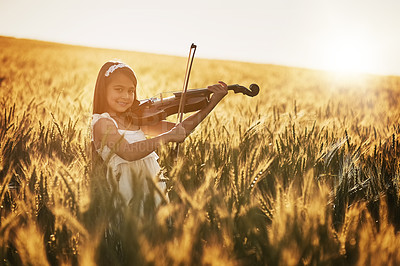 Buy stock photo Portrait, girl and playing violin with talent, concert performance and outdoor practice in cornfield. Young child, string instrument and music maestro in nature for creativity, development and growth