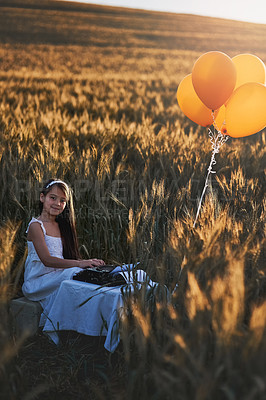 Buy stock photo Girl child, portrait or typewriter in outdoor for vintage play or dream career, writer or editor with antique. Female kid, typing or retro machine for future job with happiness in nature, fun or game