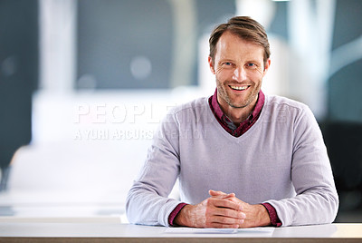 Buy stock photo Portrait of a mature businessman sitting at a desk in an office