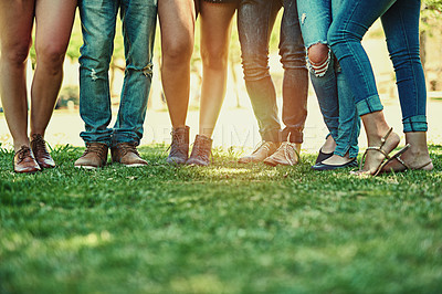 Buy stock photo Cropped shot of a group of stylish young people standing together outside