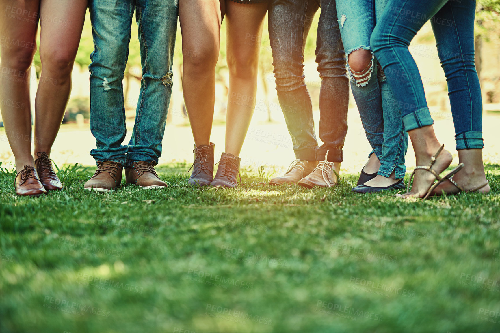 Buy stock photo Cropped shot of a group of stylish young people standing together outside