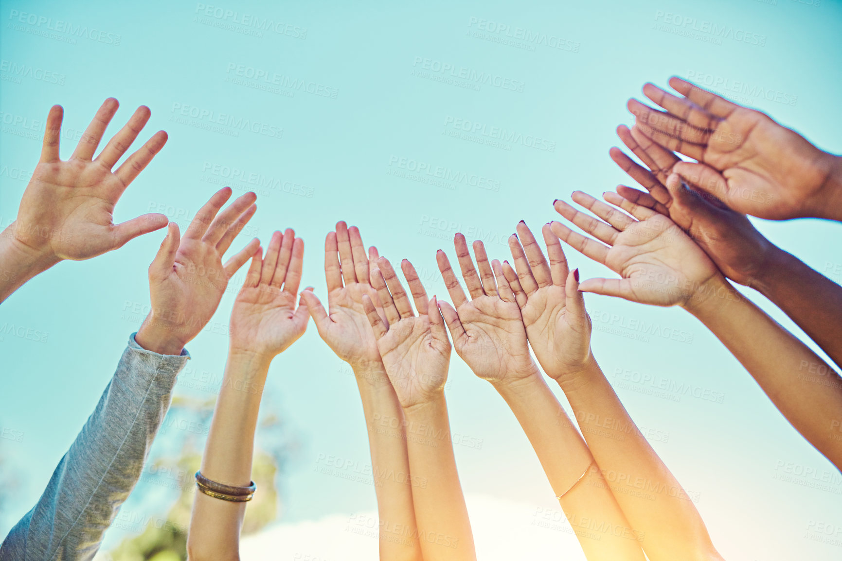 Buy stock photo Group of people, blue sky and hands on air for teamwork, partnership and support with motivation. Friendship, diversity and collaboration for equality, freedom and solidarity as community outdoor