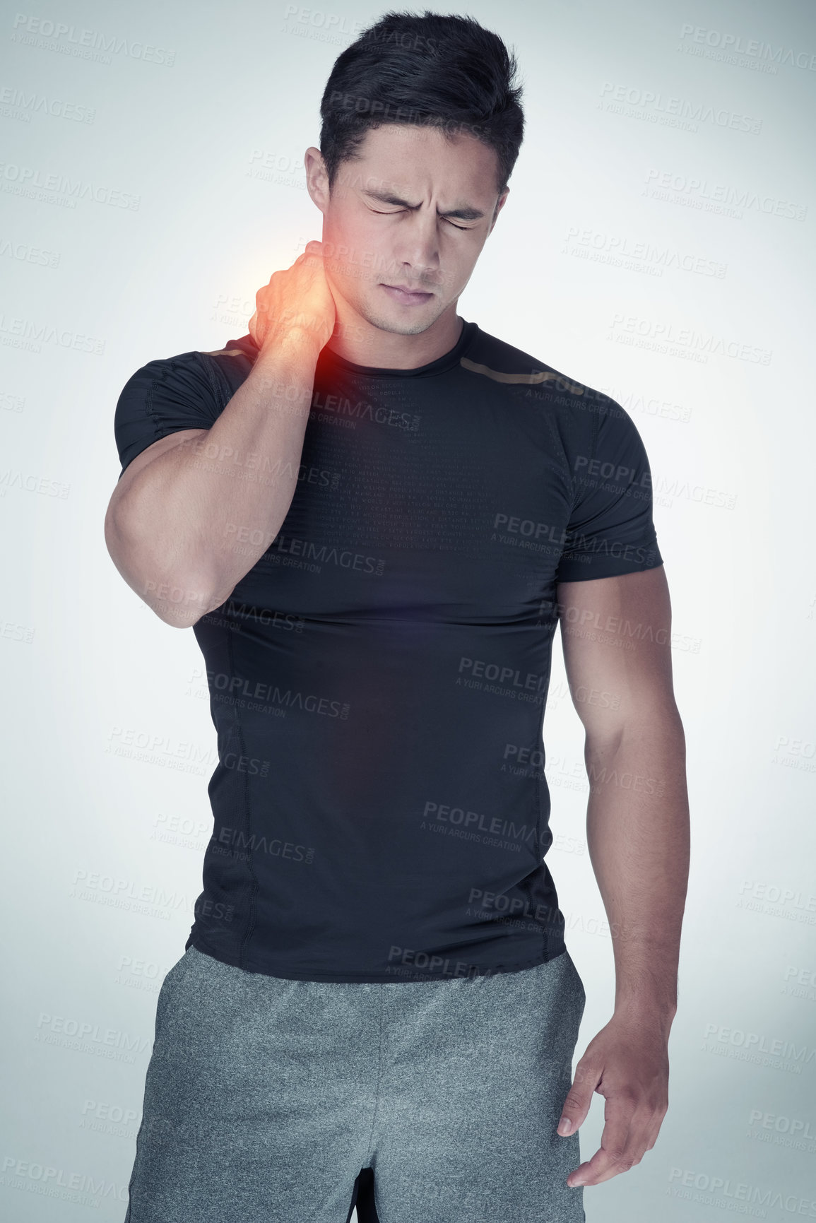 Buy stock photo Studio shot of an athletic young man suffering with neck pain against a grey background