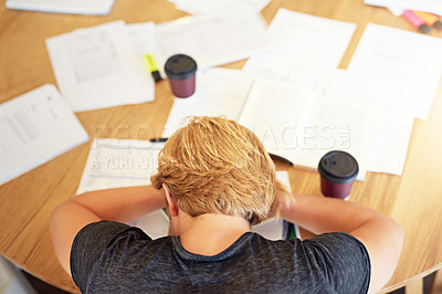 Buy stock photo High angle shot of an exhausted young student sleeping with his head on a cafe table