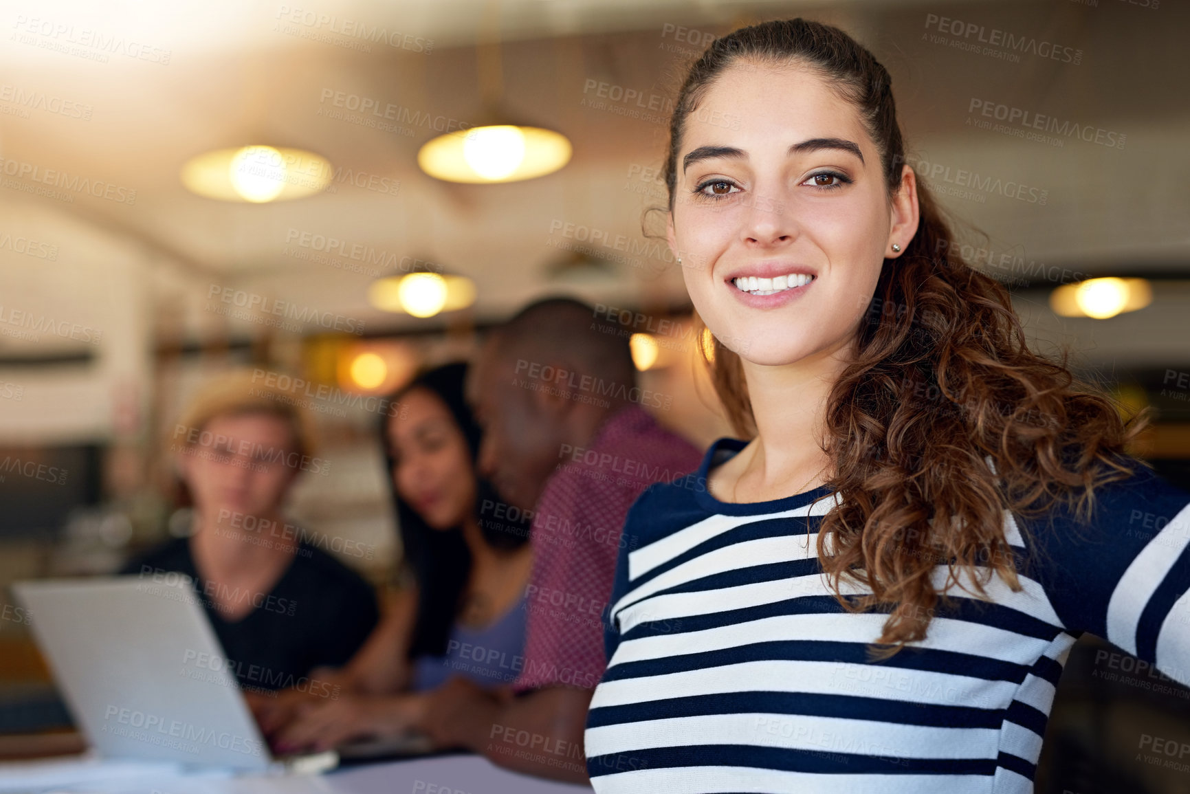 Buy stock photo Portrait of a happy young student posing in a cafe with her friends