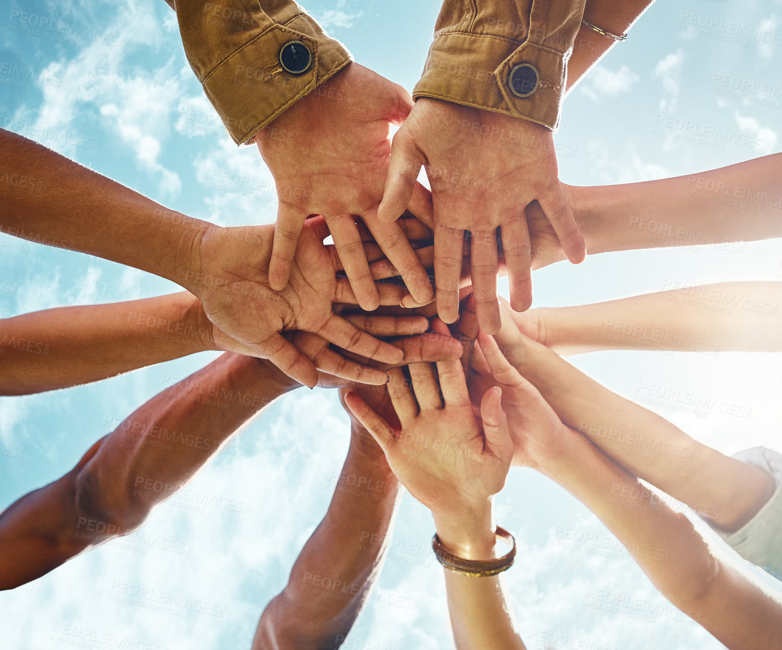 Buy stock photo Bottom, people and hands in support of collaboration, trust or solidarity on blue sky background. Teamwork, friends and low angle hand of person group outdoor for team building, partnership or goal