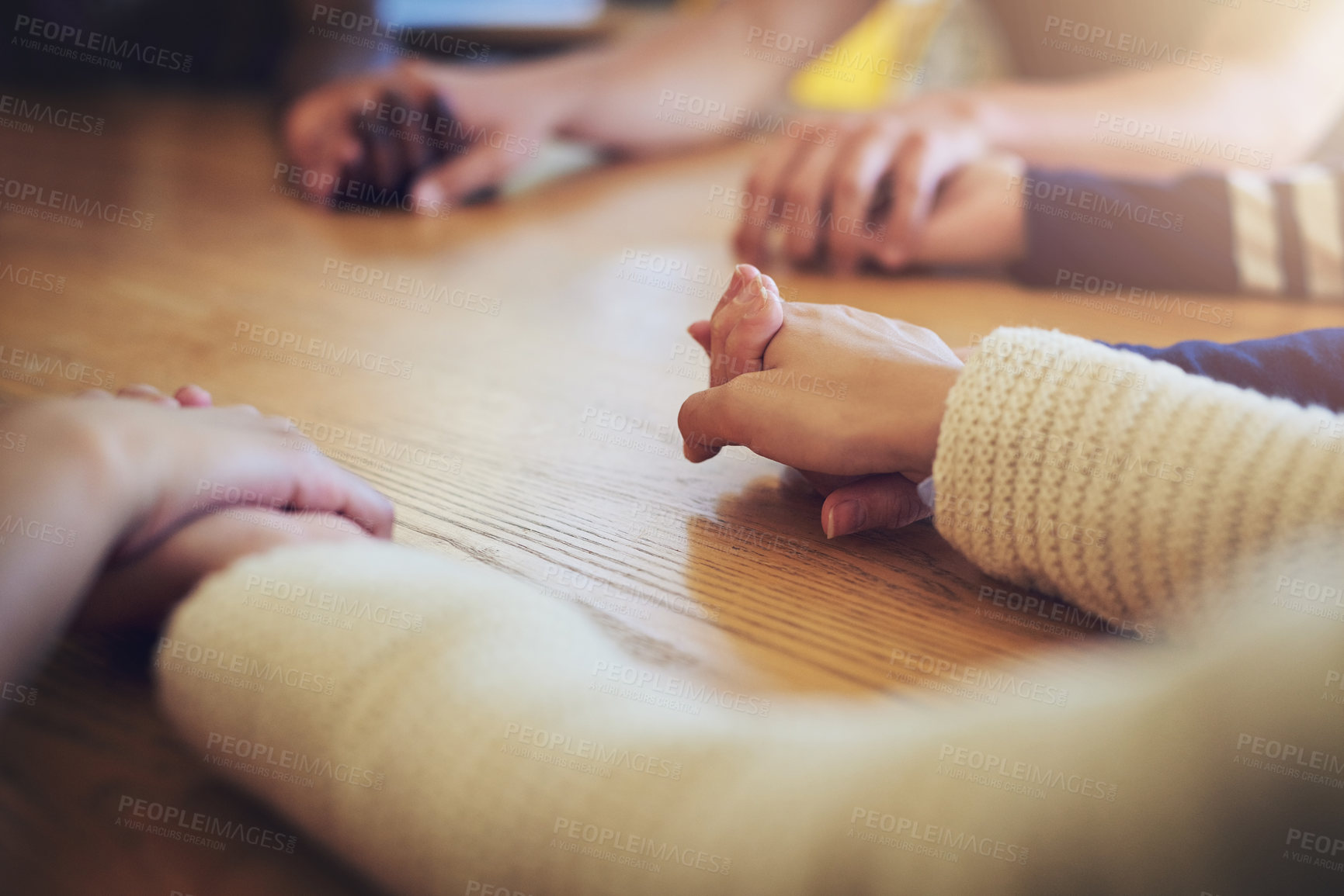 Buy stock photo Circle, group and holding hands with people, praying and support for faith, trust or solidarity on desk. Teamwork, helping hand and together with pray, religion or spiritual with mindfulness on table