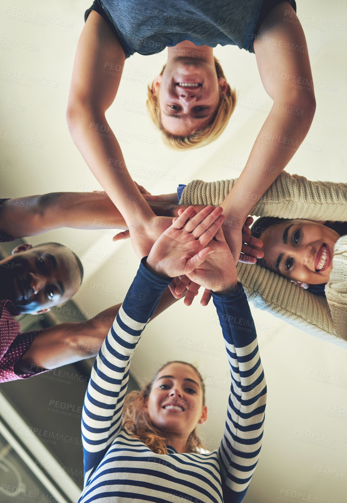 Buy stock photo Low angle, portrait and students with hands, stack and cooperation with happiness, education and smile. Face, people and group with teamwork, collaboration and knowledge with scholarship and success