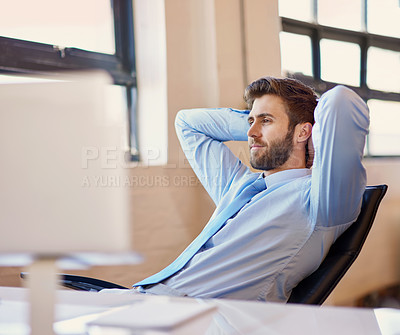 Buy stock photo Shot of a happy businessman working at his computer in the office