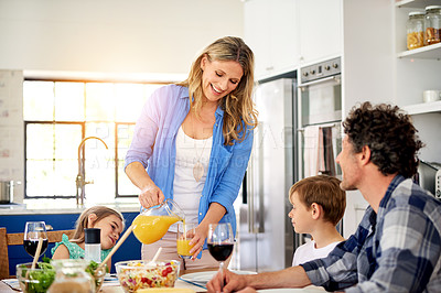 Buy stock photo Shot of a happy family enjoying a meal together at home