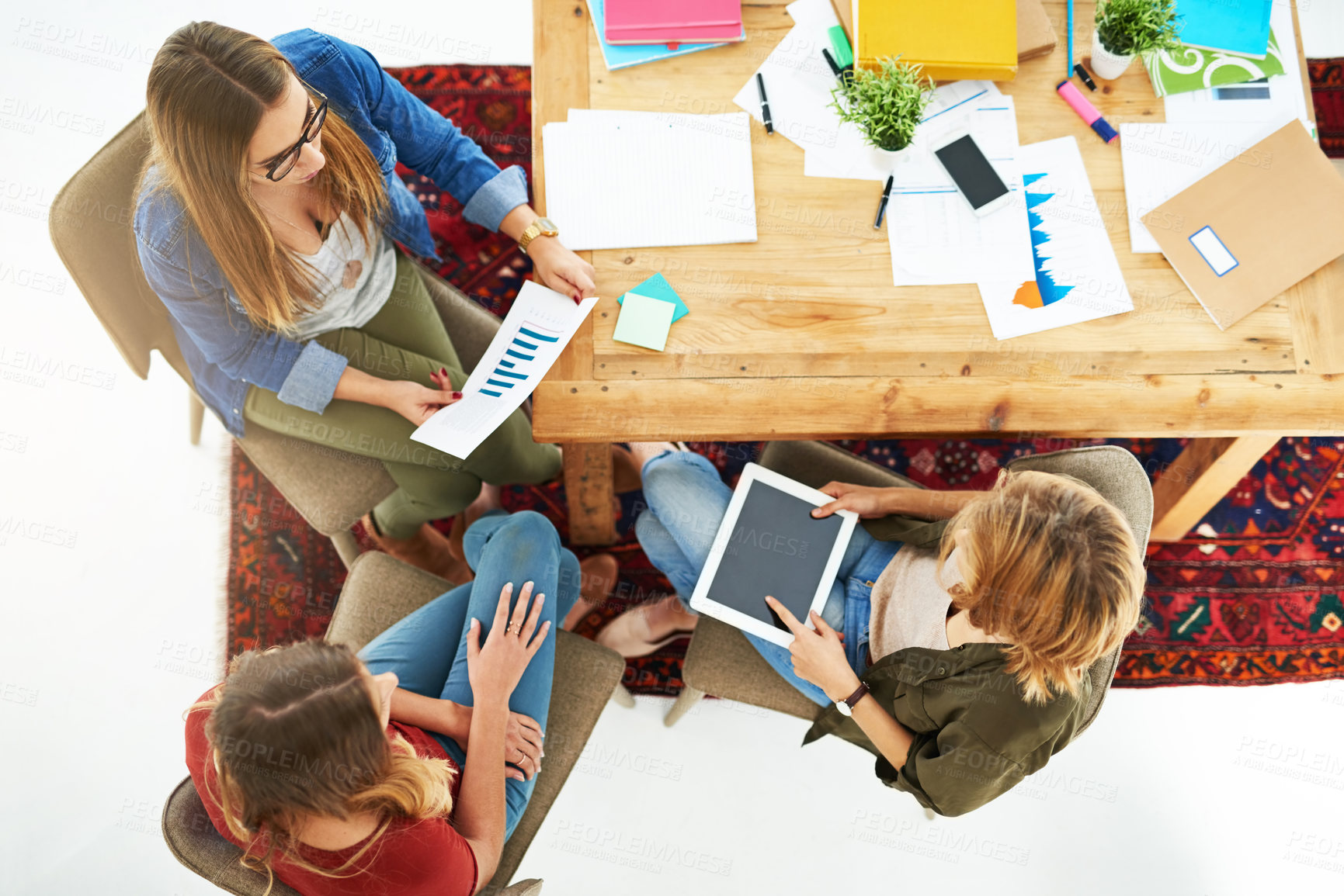 Buy stock photo High angle shot of a group of female university students working on a project together at a table on campus